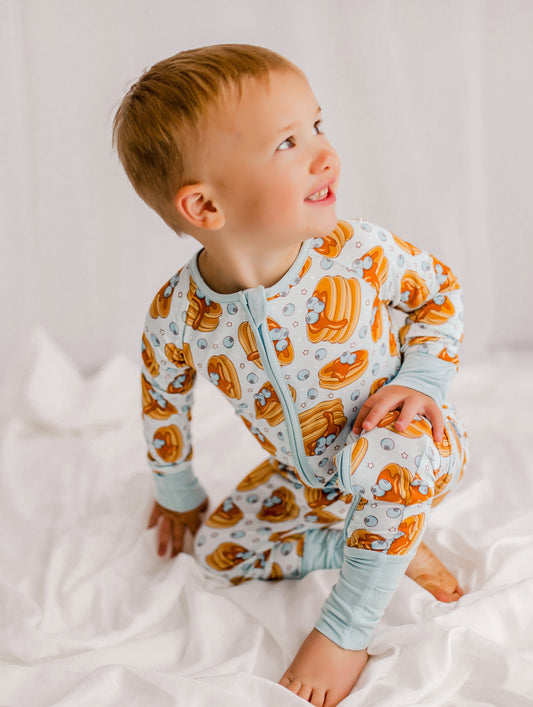 Child wearing pancake themed pajamas with Maine blueberries and syrup
