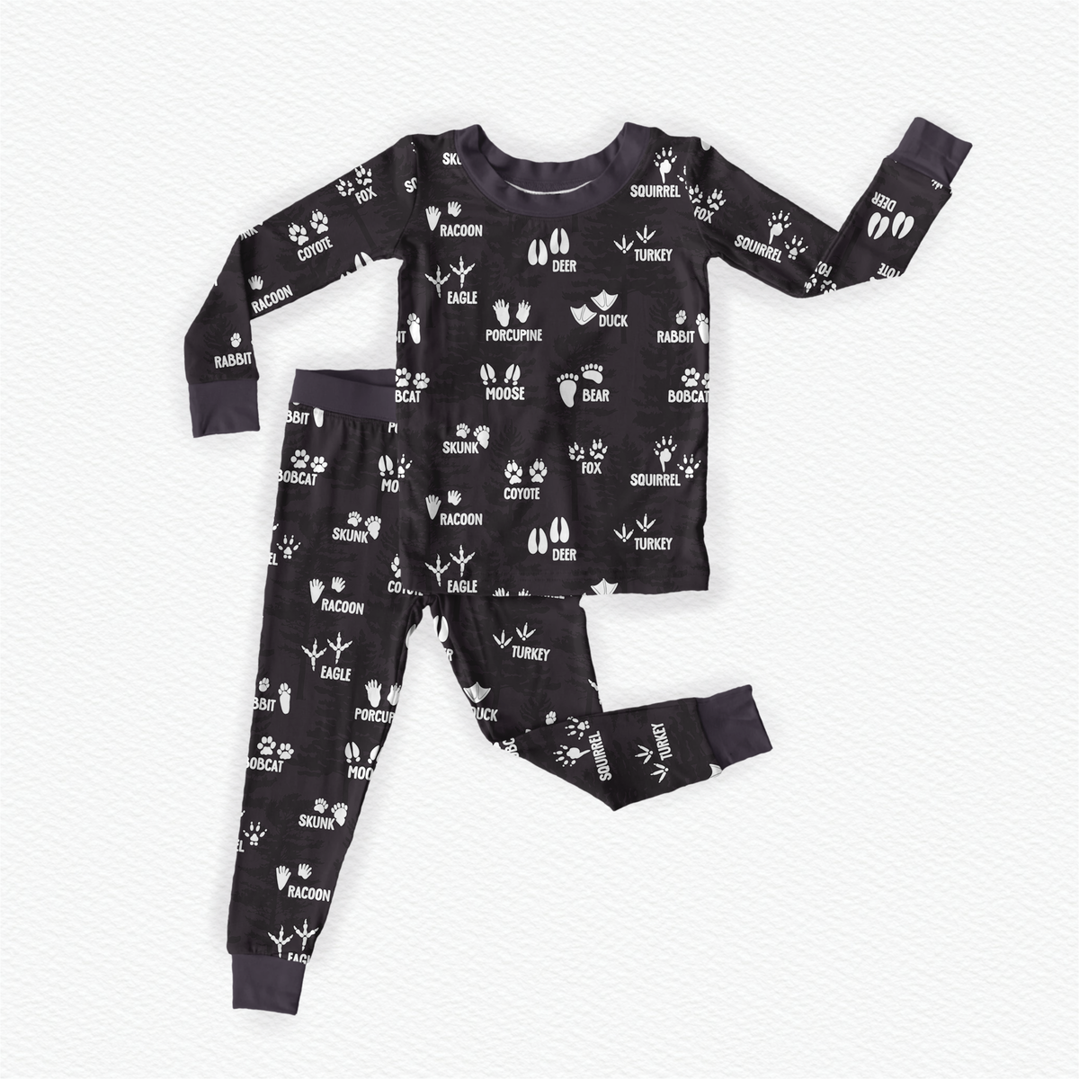 Charcoal pajama set with white wildlife tracks with the name of the animal in white beside or underneath the tracks.