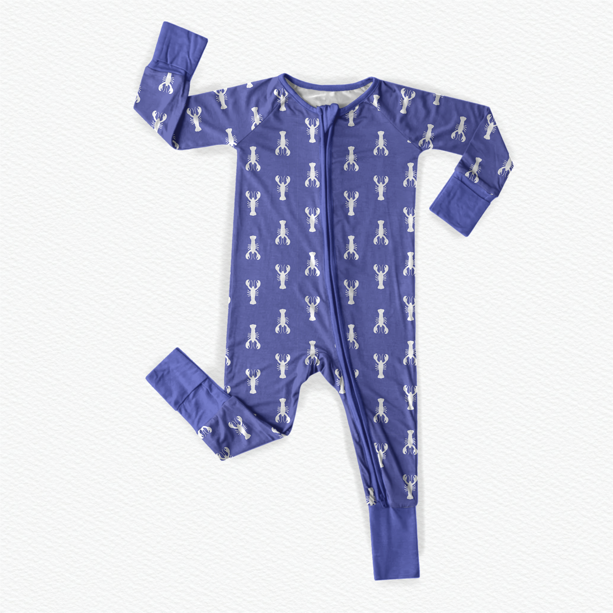 A long-sleeved purple baby onesie with a pattern of white lobsters with purple cuffs