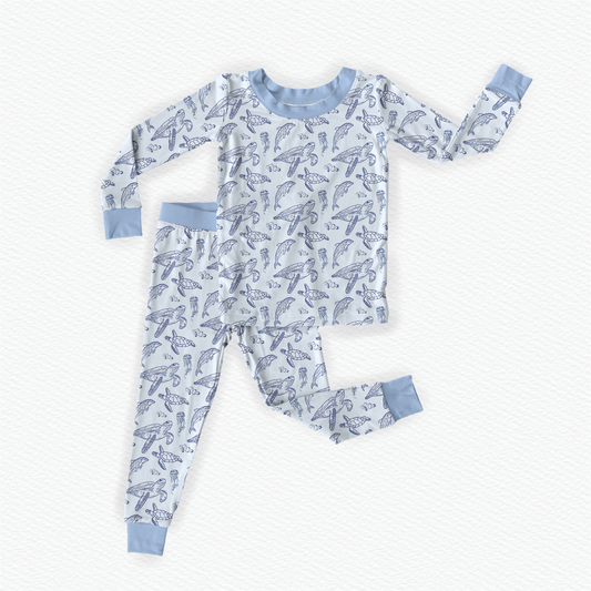 Sea turtles, jellyfish, and dolphins on a light blue background with blue cuffs