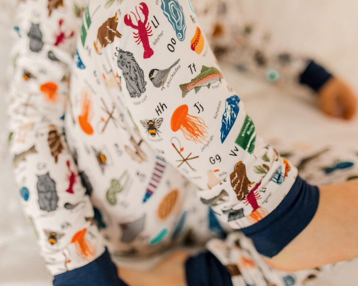 Children's pajama set with blueberries, moose, lobsters, waffles, hotdogs, oysters, chickadee, and so much more to make the maine alphabet