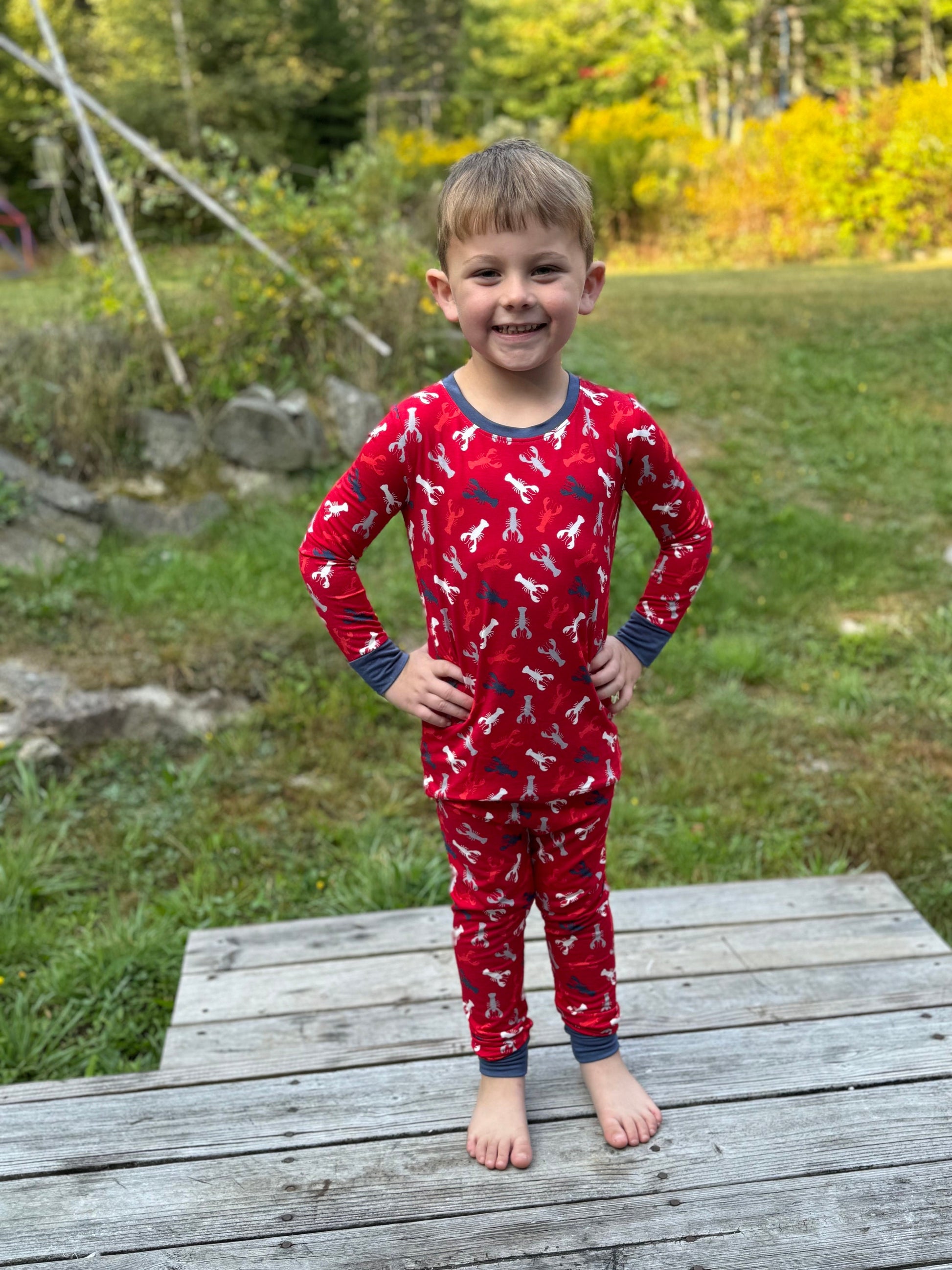 Maine-inspired red lobster print pajama set worn by child, cozy everyday sleepwear