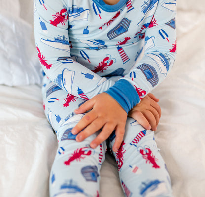 Maine-themed lobster and lighthouse print with coastal icons including lobster boats and buoys on a light blue background