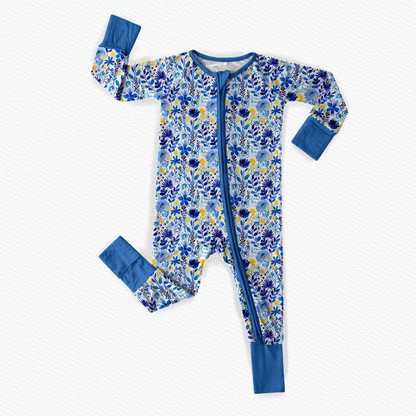 A vibrant yellow and blue floral print one piece pajama with long sleeves and foldable cuffs of the wildflowers of Maine 