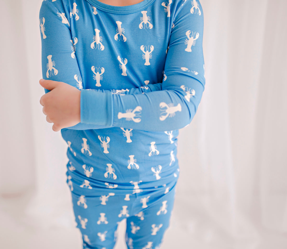 Long sleeve blue pajama set with maine blue lobster pattern and blue cuffs 