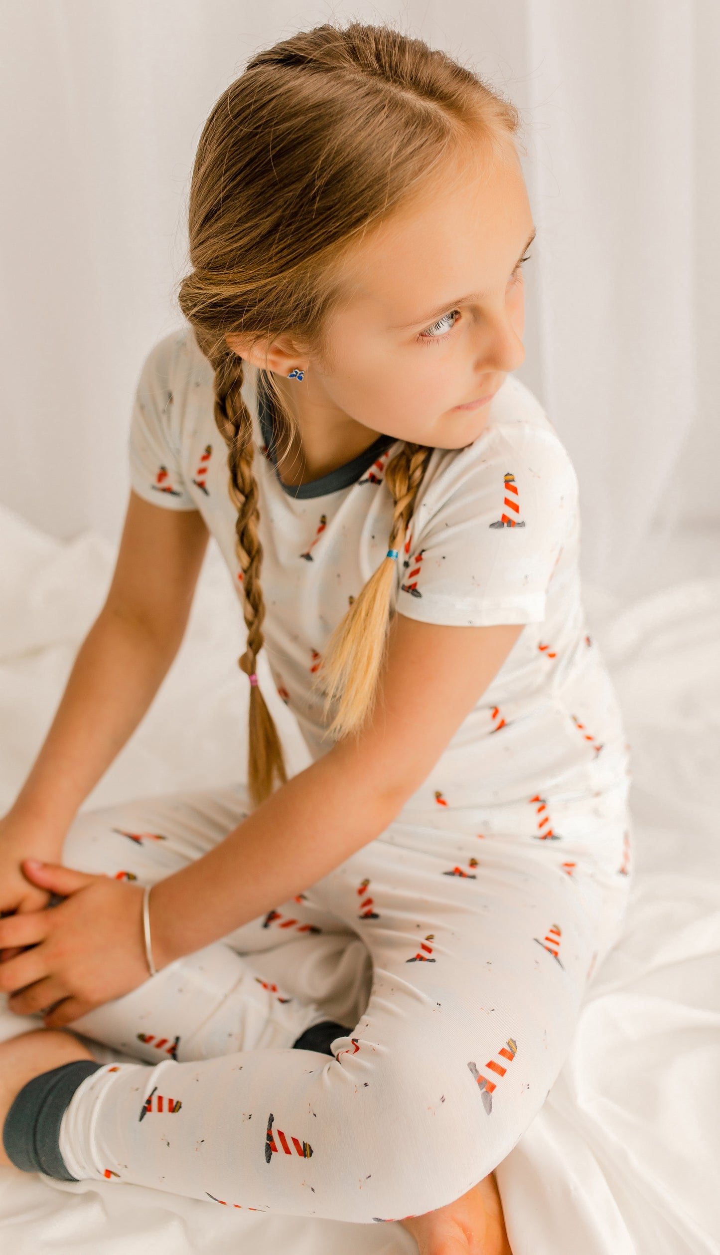 Short sleeved pajama set of Maine lighthouses on the coast on a white background and black accents 