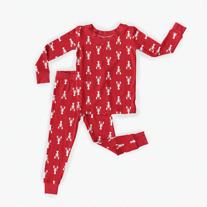 Long sleeved two piece pajama set of coastal Maine white lobsters on a red background 