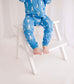 Child wearing baby blue zippy romper with white lobster pattern 