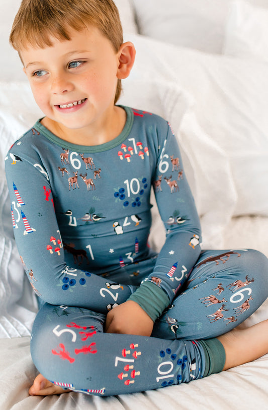 Child wearing grey pajamas with numbers and Maine icons