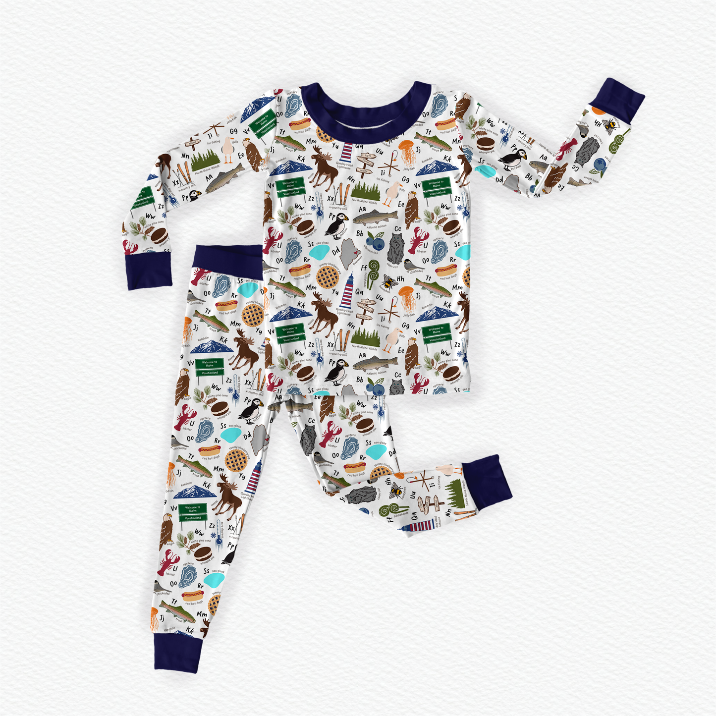 Child wearing pajamas with nature-themes, food themes, animal themes, and ocean themes to make up the Maine alphabet 