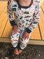 Child wearing pajamas with nature-themes, food themes, and animal themed to make up the Maine alphabet 