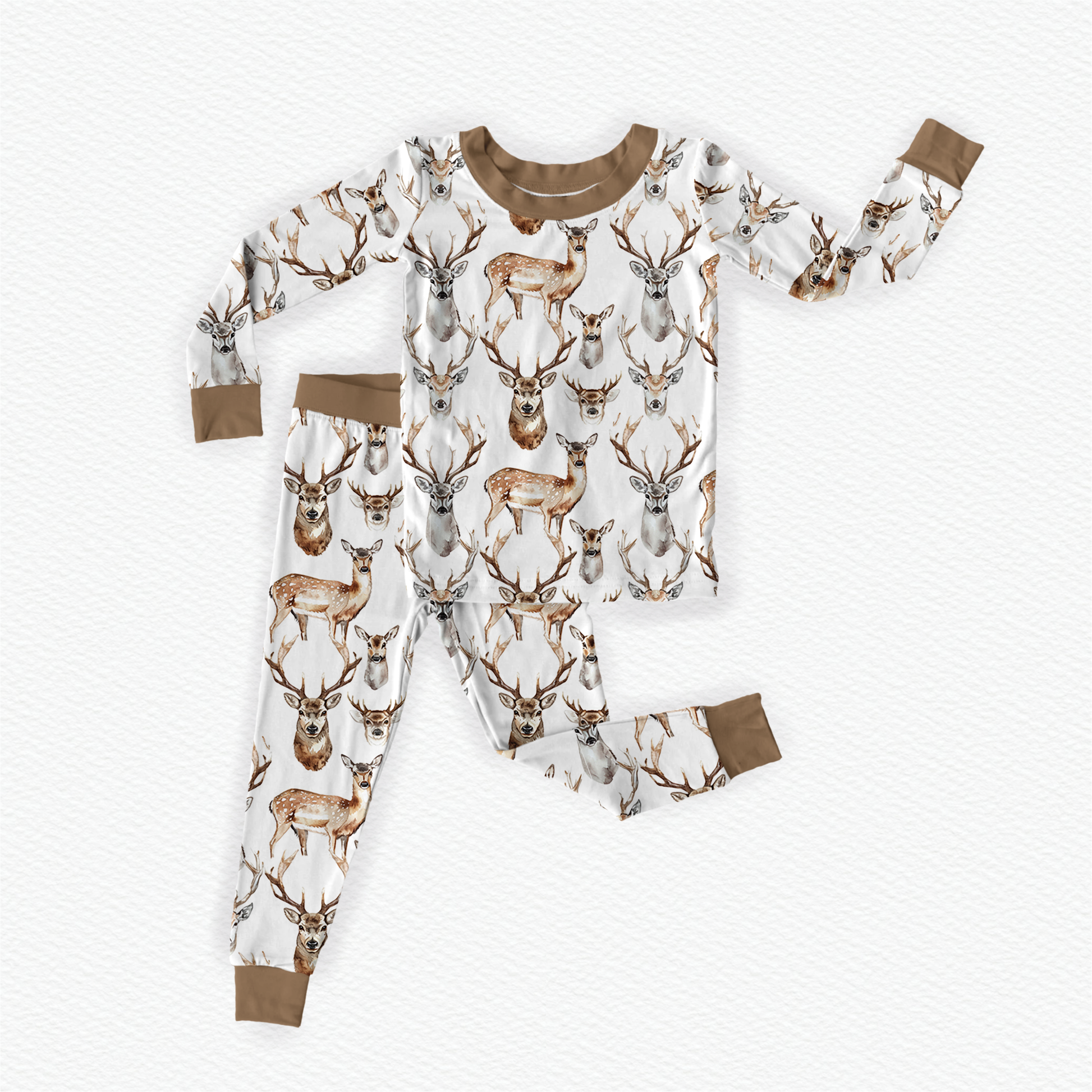 A two-piece pajama set for children with a deer and antler design on a white background and brown accents.
