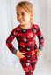 Child wearing red plaid two piece pajama set with trees from the Maine forest and white moose 