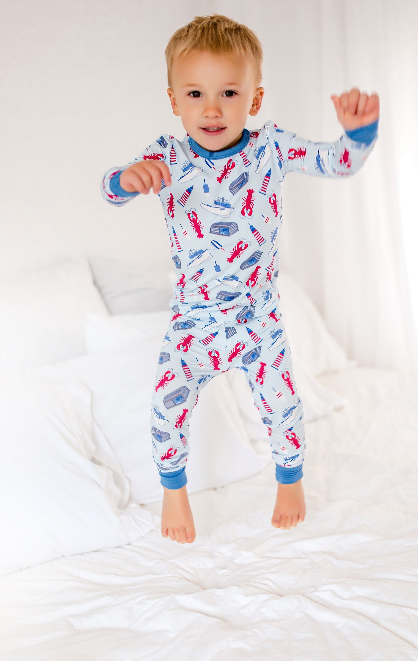 Playful Maine coastal print inspired by lobster fishing, featuring lobsters, boats, and nautical icons.