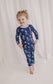 Child wearing two piece pajama set with a jellyfish theme with colors of purple, pink, orange, and teal. 