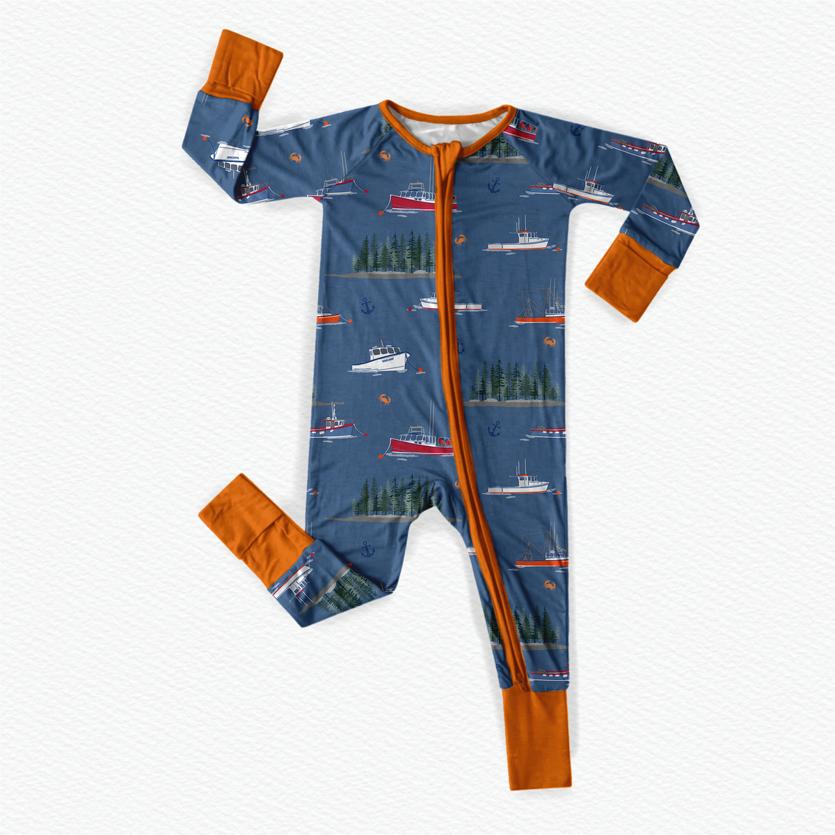 Children's onesie with boat and forest pattern on a blue background