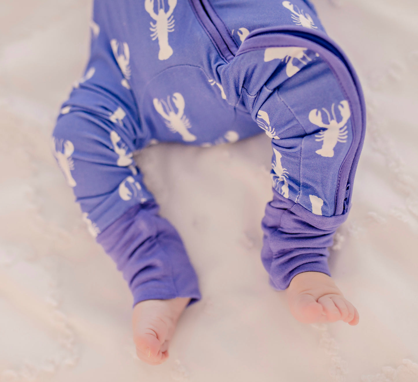 Long sleeve and pants one piece pajama with a beautiful purple background with white lobster pattern 
