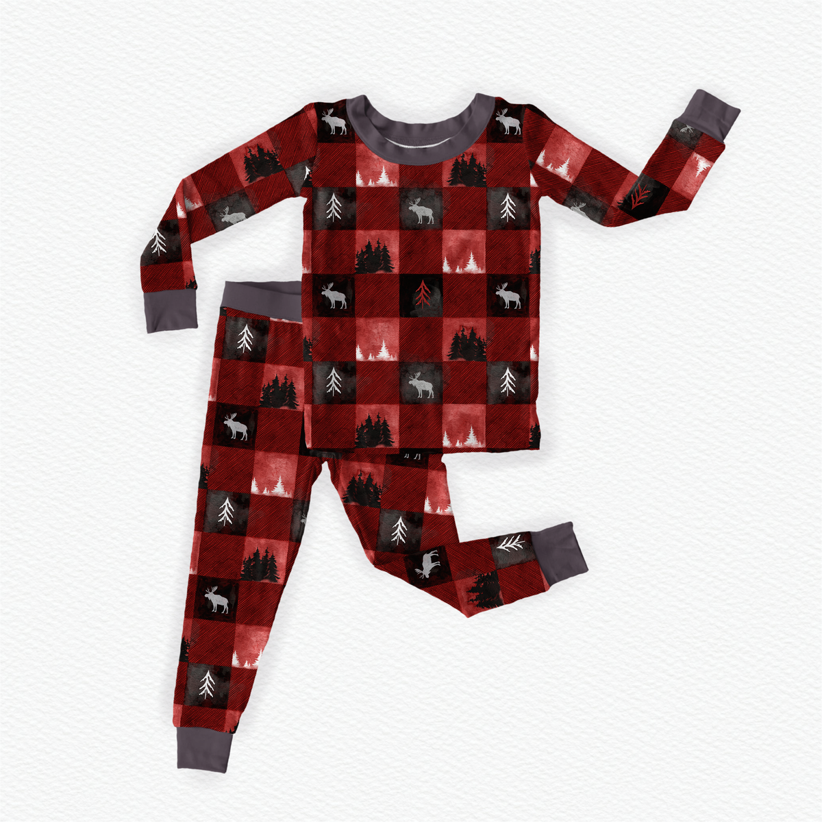 Children's long sleeve pajama set with red and black checkered pattern with white moose on the black squares and different kind of trees on the red and black squares with gray accents 