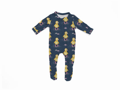 Navy baby onesie with yellow ducks in purple rain boots stomping in puddles with paper boats floating 