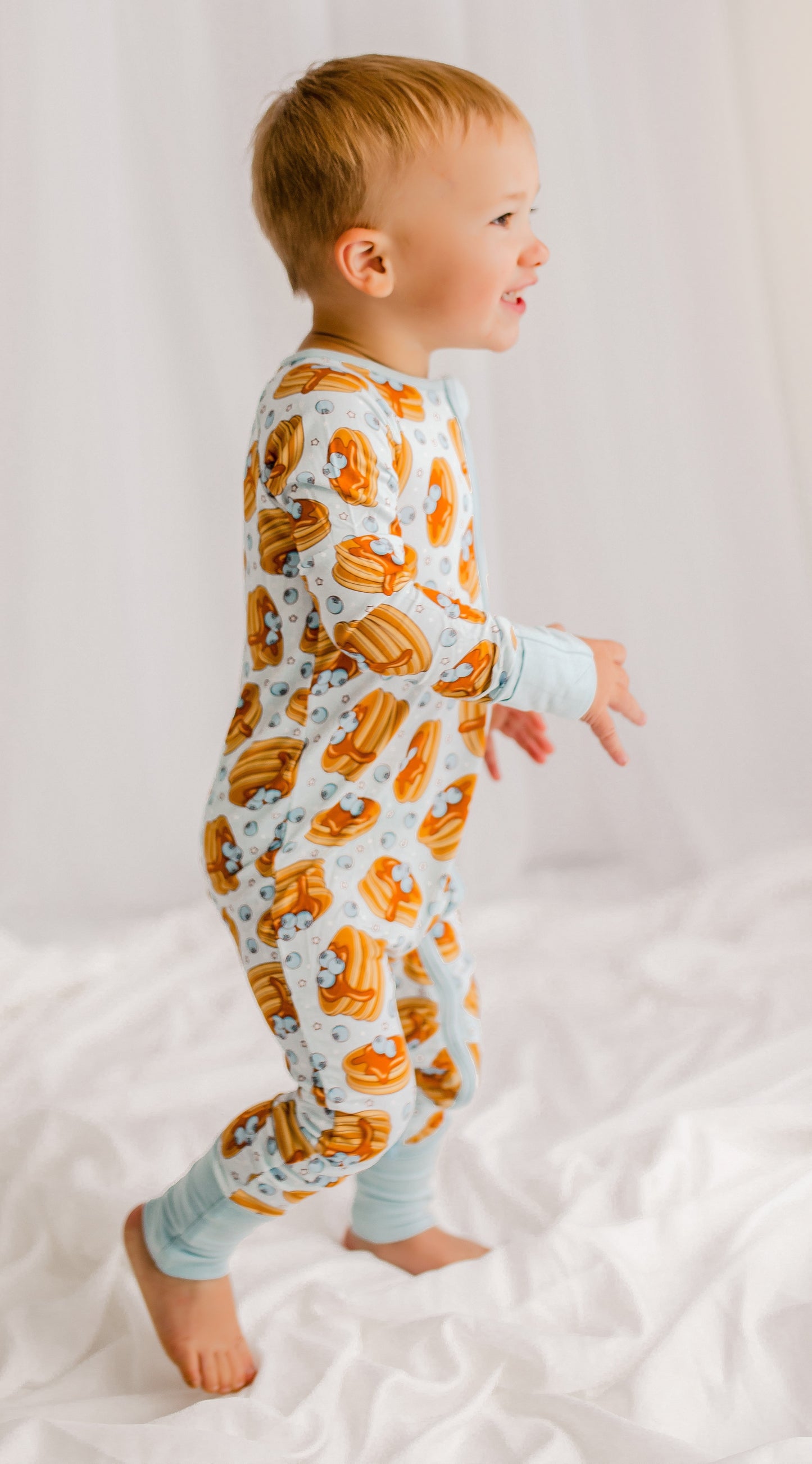 Light blue zippy romper with blueberries from Maine, pancakes with dripping syrup and stars 